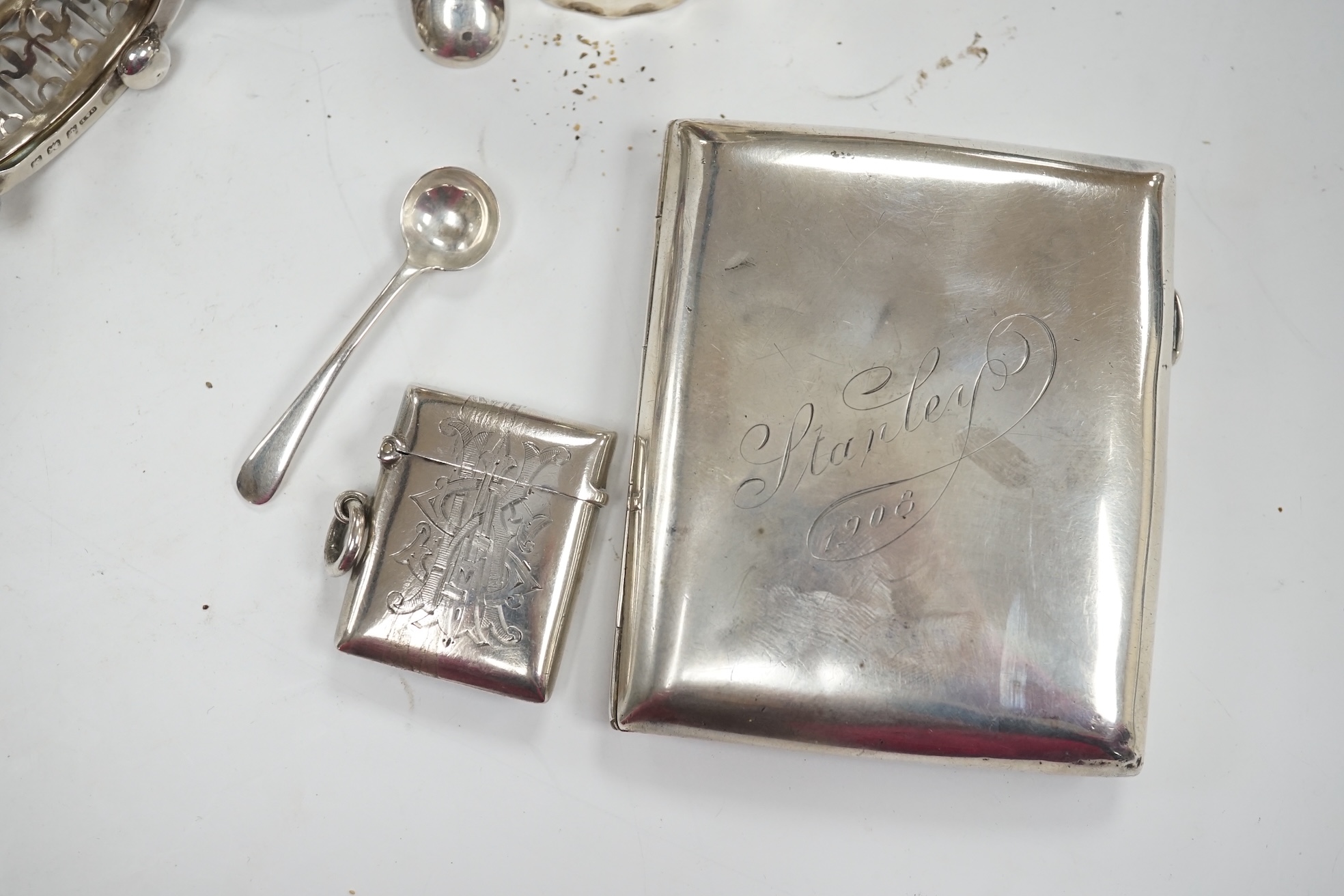 Assorted small silver ware including two vesta cases, cigarette case, matchbox sleeve, napkin rings, pair of sugar tongs and assorted condiments. some lacking liners. Condition - poor to fair